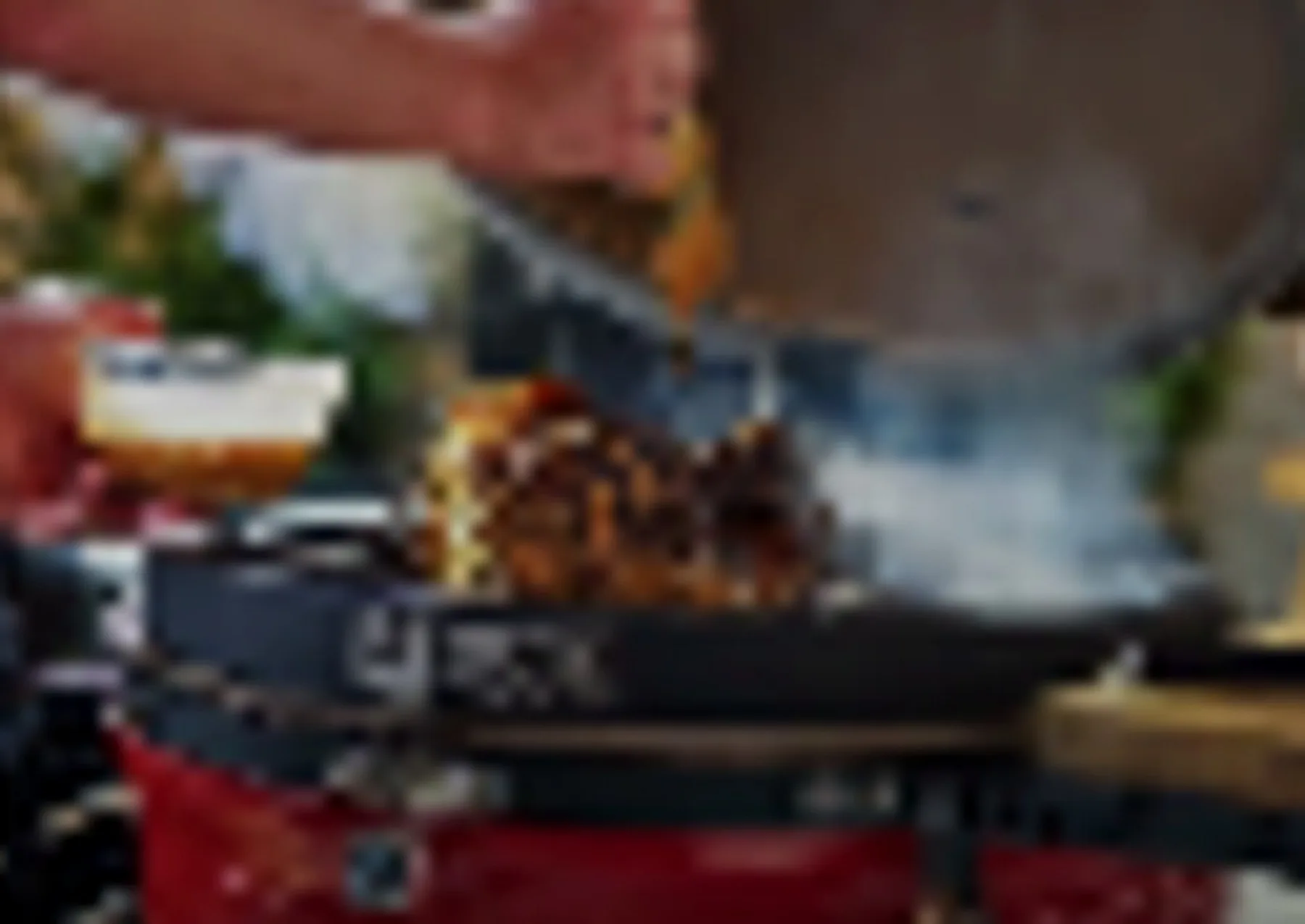 Cook preparing food on an outdoor grill