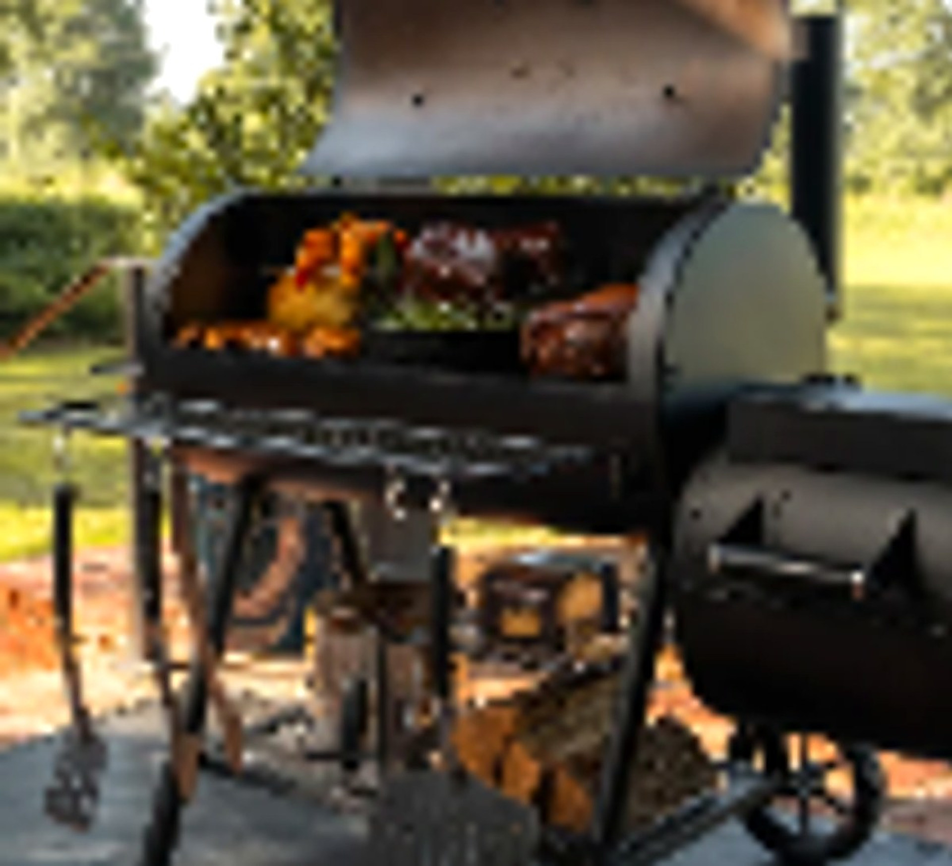 Large steel offset smoker in an outdoor cooking environment